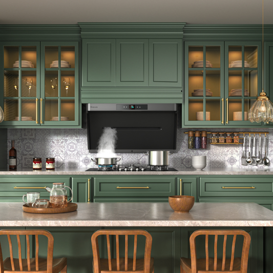 Elegant sage green kitchen with glass cabinet doors, marble countertops, and a black range hood capturing steam from cooking