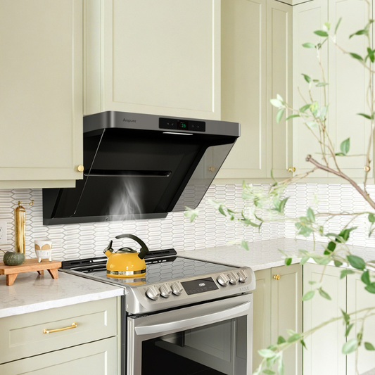 Black Arspura range hood mounted on a cream-colored kitchen wall with a digital display showing '26'. The hood is positioned above a stainless steel cooktop with a yellow kettle, demonstrating modern kitchen ventilation