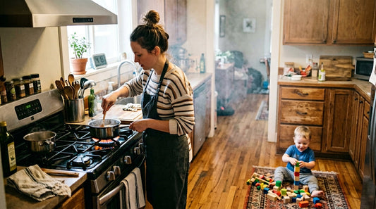 Parent cooking at gas stove with toddler nearby showing kitchen air quality risk