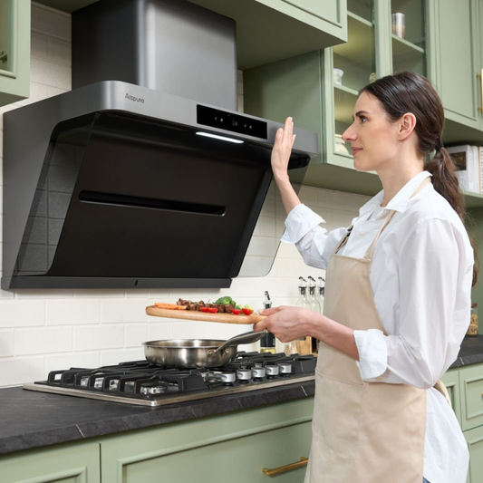 A woman holding a cutting board of food while using gesture controls to turn on an Arspura motion-sensor range hood