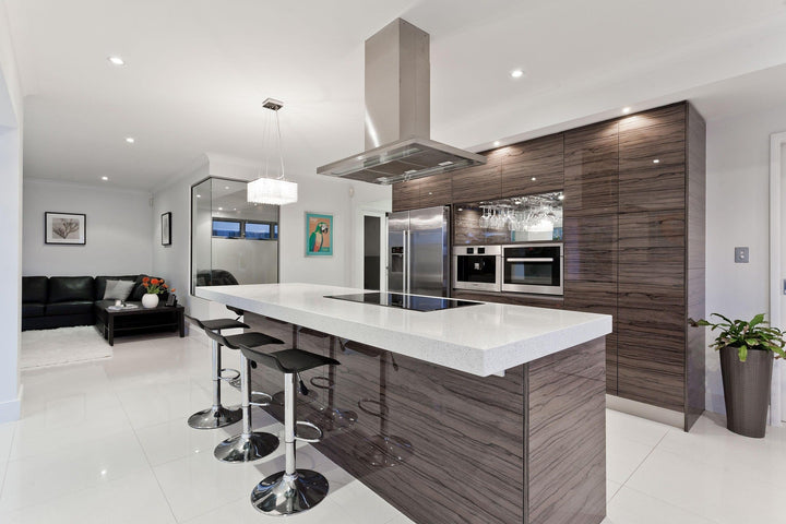 Spacious modern kitchen with an island cooktop and a ceiling-mounted range hood