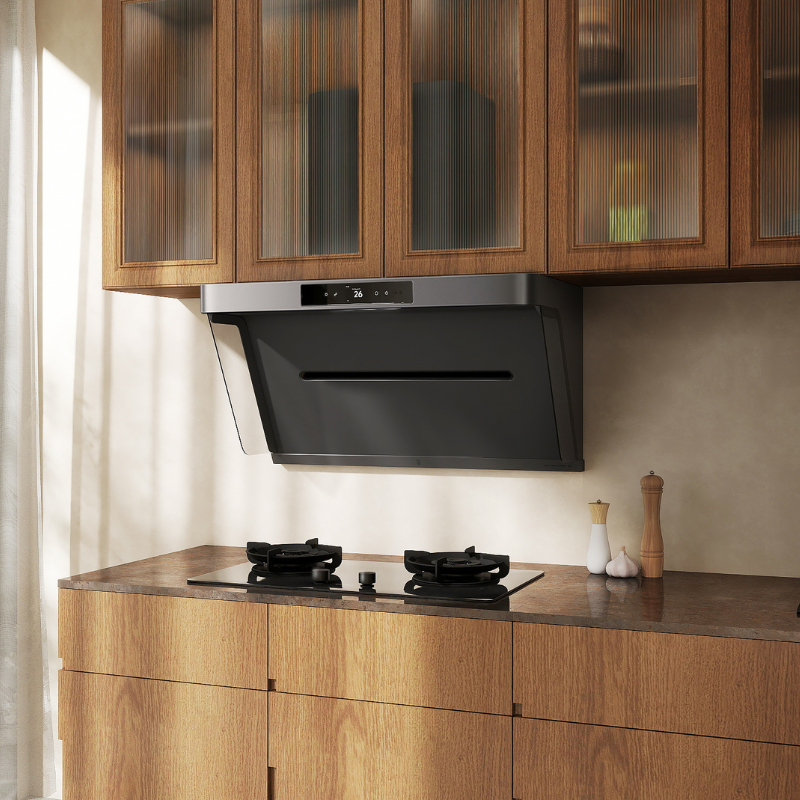 Black angled range hood with stainless steel trim and digital display showing 26 degrees, mounted under wooden glass-front cabinets above gas cooktop