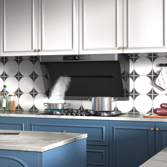 Black angled range hood with digital display mounted under white cabinets above gas cooktop with two stainless steel pots, geometric tile backsplash