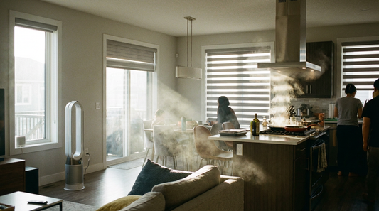 Air purifier in living room corner with cooking haze drifting from open-concept kitchen